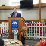 Pastor speaking at Metropolitan Ministries' Holiday Service in Pasco