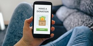 Woman donating gifts to families in need during the holidays
